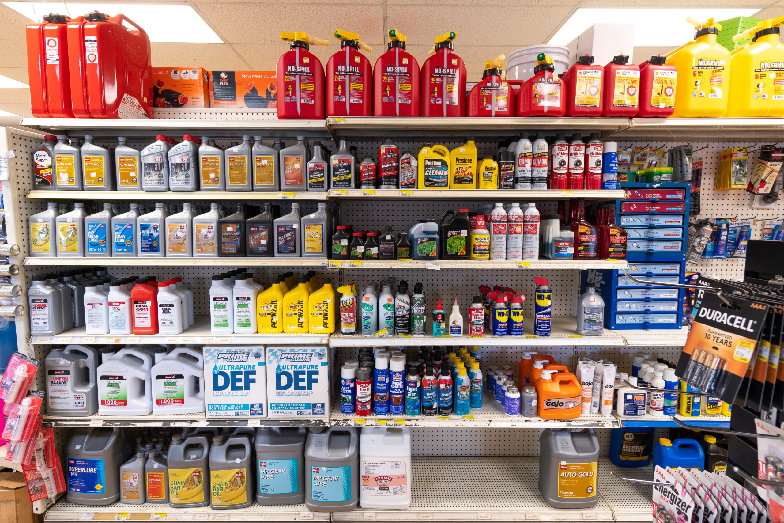A shelf at Four Star containing brands like Cenex, Mobil, & Pennzoil