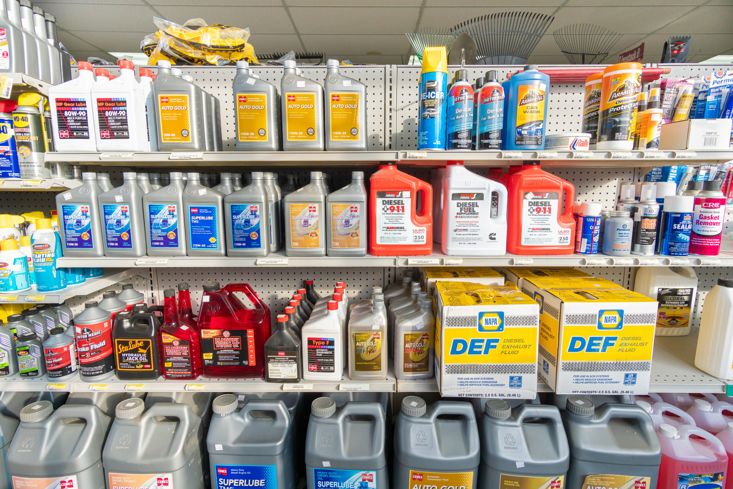 A shelf at Four Star Supply holding products by Cenex, Power Service, Armor-All, Motor Medic, & others such as De-Icer, ATF, & Engine Oil
