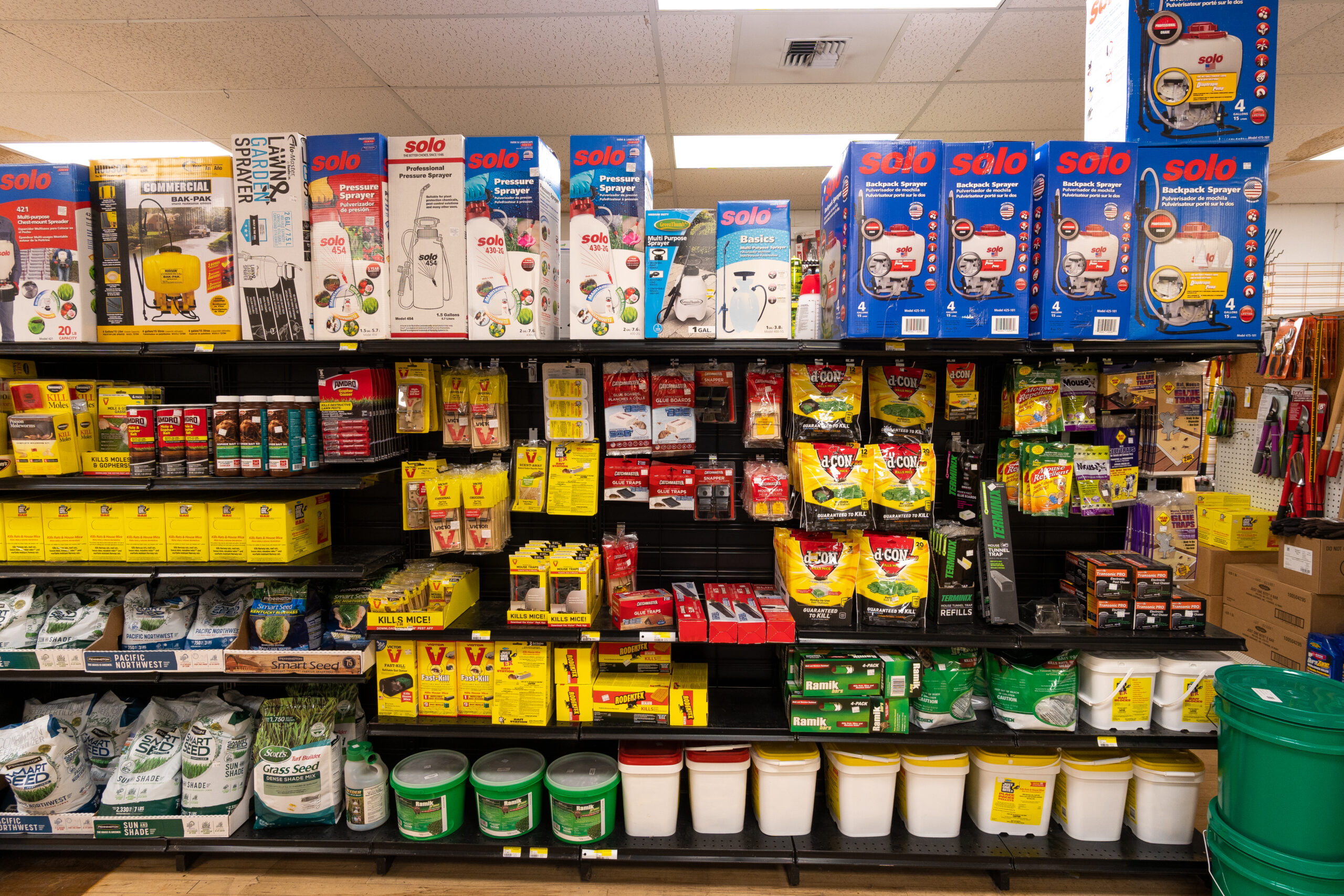 A shelf full of gardening supplies & pest control products