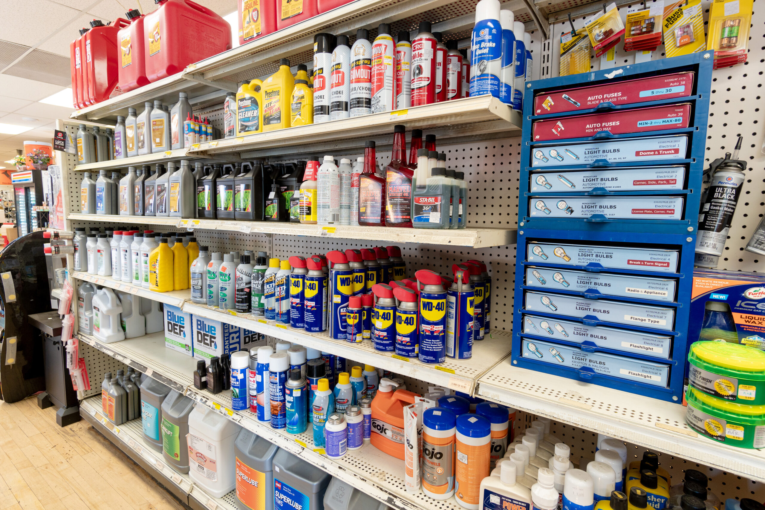 A shelf at Four Star containing brands like WD-40, Gum Out, Prestone, and Cenex