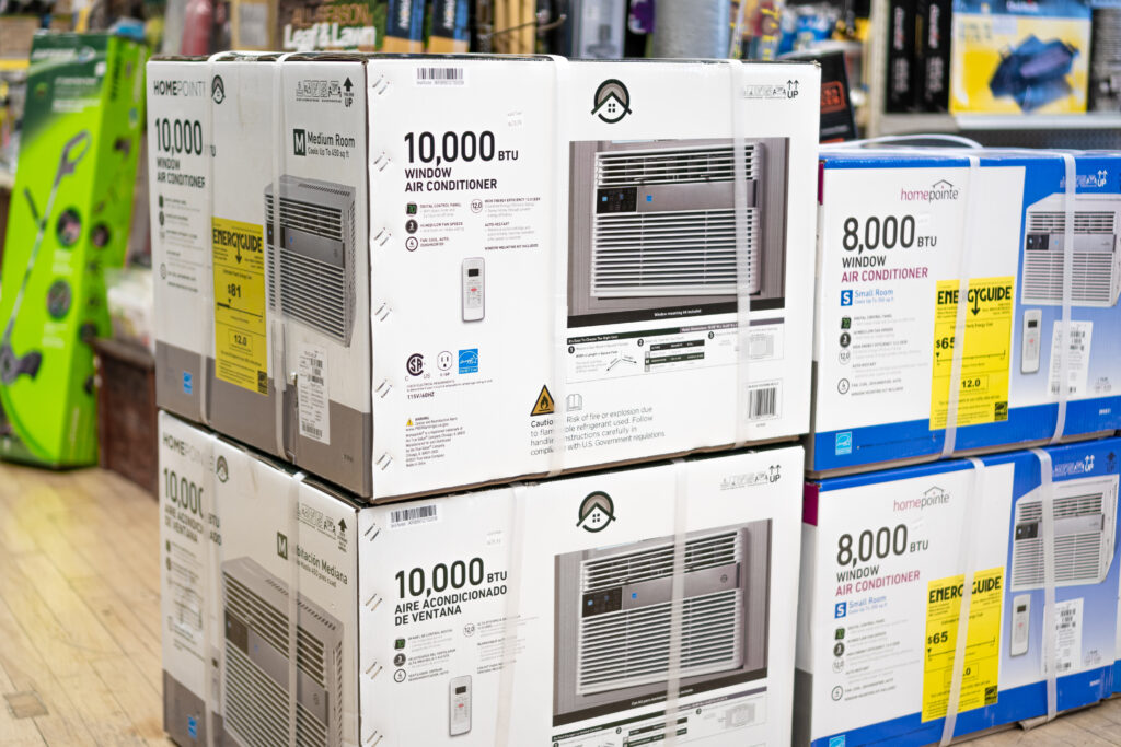 Several Boxes of Homepointe Air Conditioners Stacked on Top of Each Other