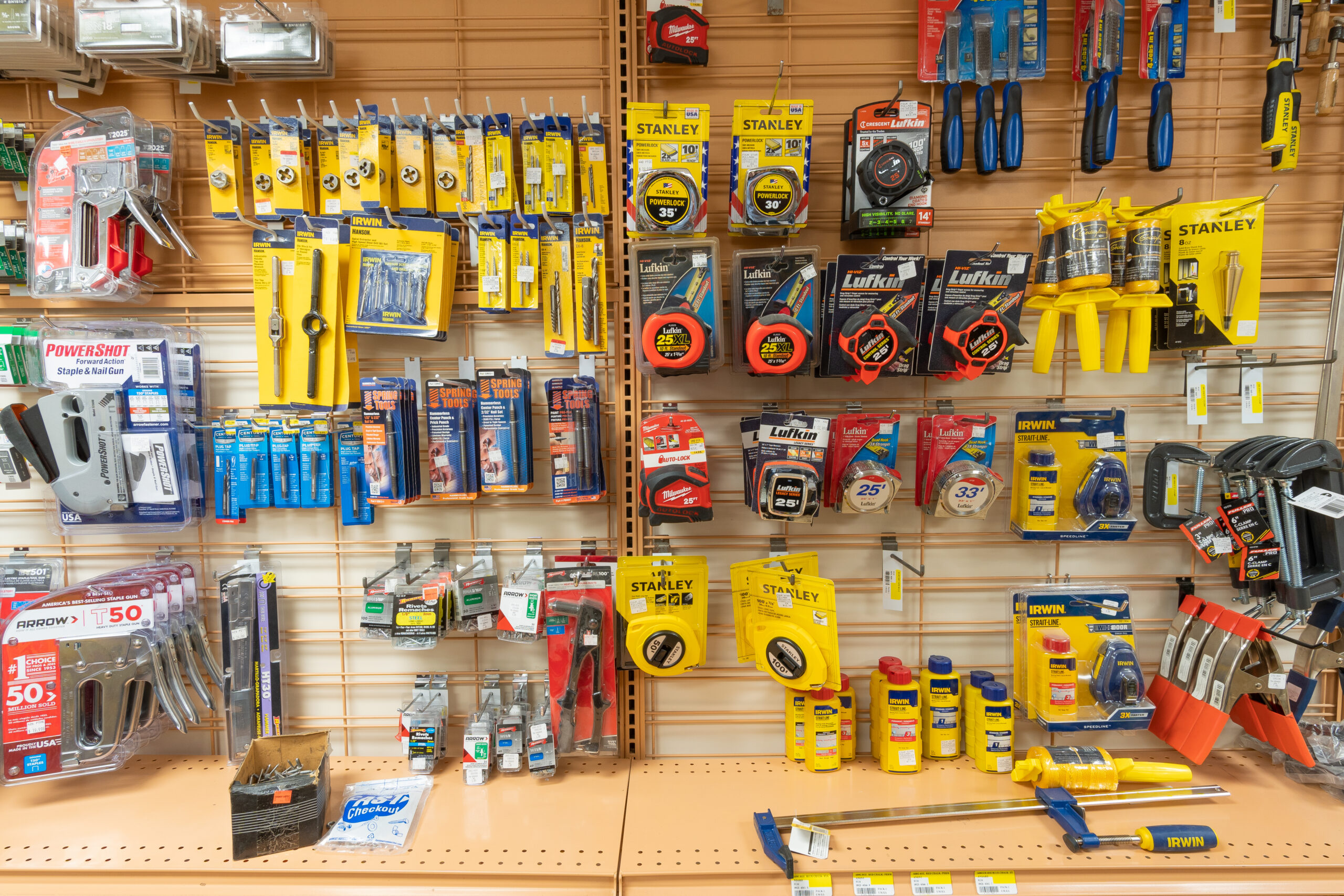 Tools like tape measures, wrenches, staple guns, and clamps.