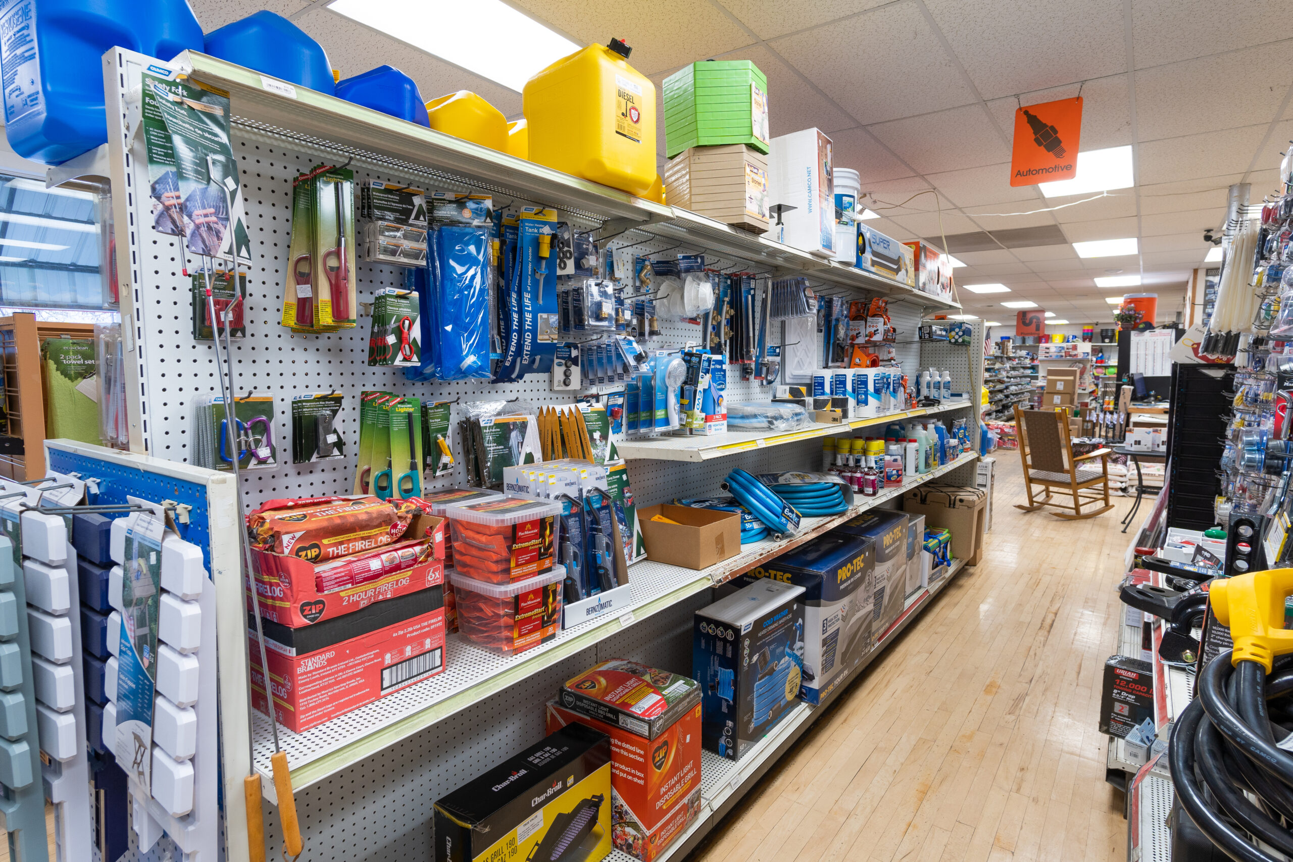 A view of shelves containing products sold by Four Star Supply, including automotive maintenance products.