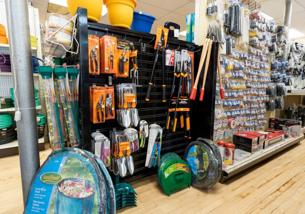 A self full of gardening supplies from the Fiskars & Green Thumb brands.