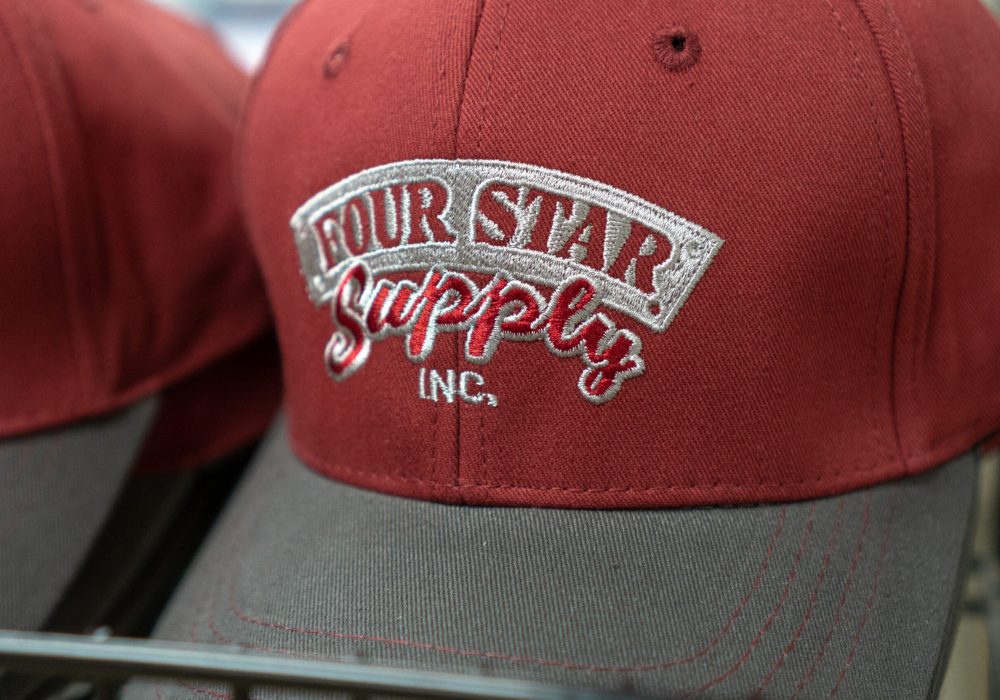 A closeup of a Four Star Supply branded Baseball hat