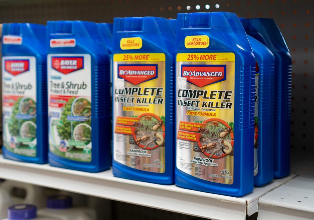 BioAdvanced Insect Killer in blue bottles next to bottles of Tree & Shrub Food from Bayer Advanced