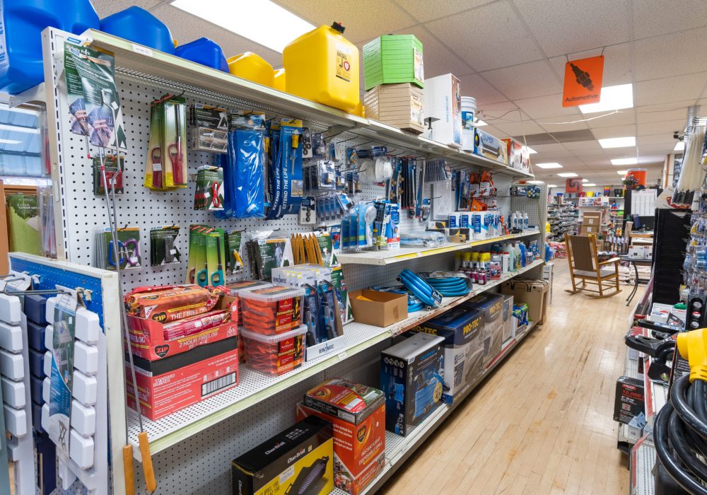 A view of shelves containing products sold by Four Star Supply, including automotive maintenance products.